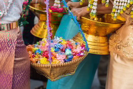 A group of people holding a basket of flowers photo