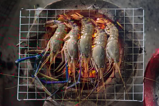 Shrimp cooking on a grill photo