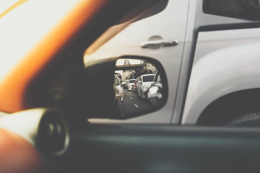 A car is seen in the rear view mirror of a vehicle photo