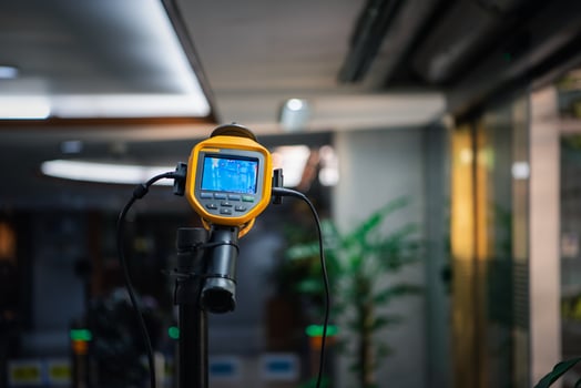 A yellow and black device on a tripod photo