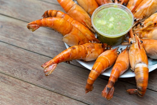 A plate of shrimp with a drink on it photo