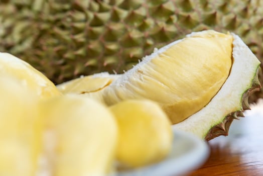 A durian fruit is cut in half photo