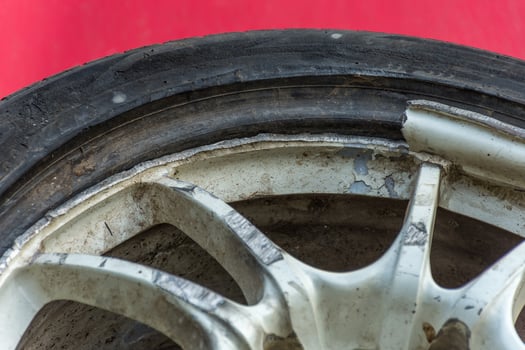 A close up of a tire with a damaged rim photo