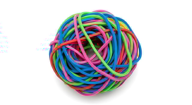 Tangled Bundle of Colorful Rubber Bands on White Background photo