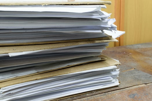 A stack of papers on a table photo