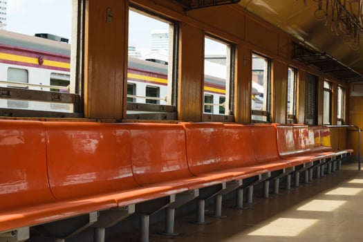 Orange benches in a train photo