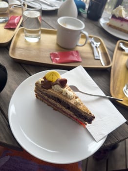 Great top view of a large delicious piece of cake, coffee and a glass of water on a wooden table in a cafe in Austria photo