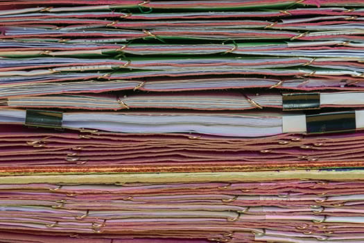 A stack of papers with many different colors photo