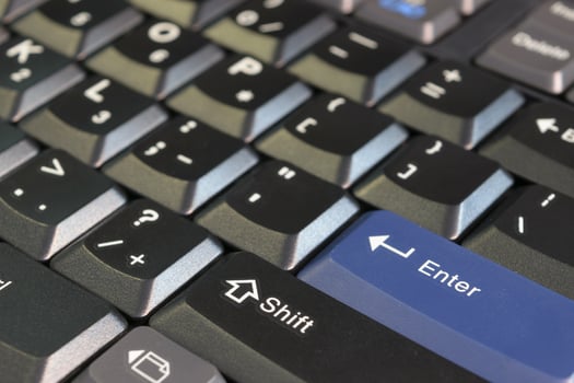 A close up of a keyboard with a blue button photo