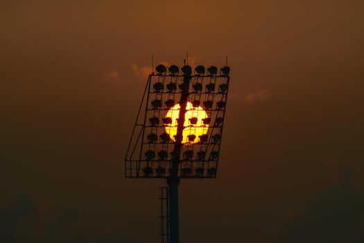A stadium with a large light on top photo