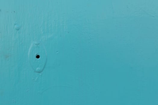 A blue wall with a hole in it photo