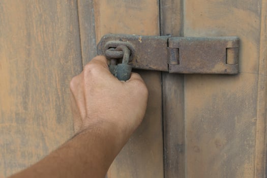 Locked vintage wooden door with hand photo