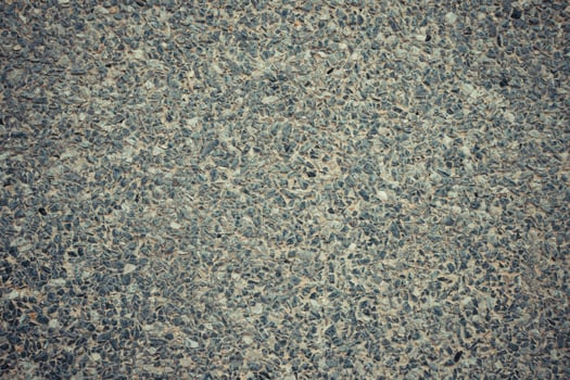 A close up of a concrete surface with a few pebbles photo
