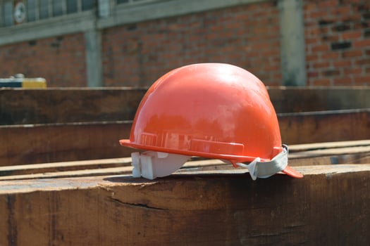 A hard hat sitting on top of a wooden beam photo