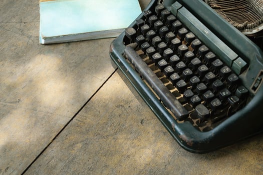 A typewriter and a book on a table photo