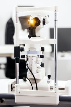Ophthalmic examination device with illuminated lens, showcasing advanced technology and precision engineering in a clinical setting, highlighting the importance of eye care photo
