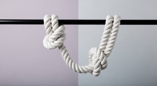 A white rope tied in a knot on a dark horizontal line photo