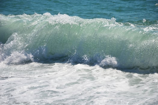 Sea wave with white foam on a sunny day. photo