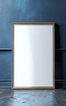 Minimalist blank picture frame leaning against textured blue wall hinting at potential waiting to be filled with art photo