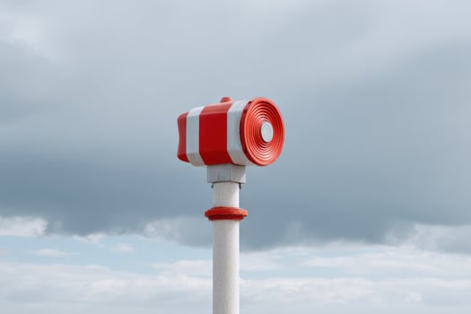 Emergency tsunami warning siren standing under a cloudy sky photo