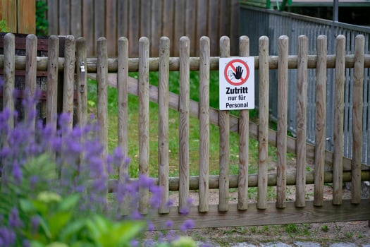 Wooden gate with sign for staff only in rural flower area photo