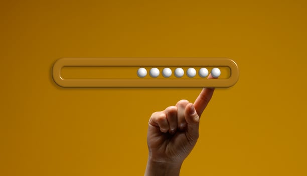 Human hand balancing horizontal loading scale with six white balls inside on index finger. photo