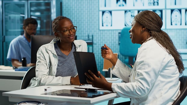 Female doctor using clinical scans and records to advise a patient during routine checkup, focusing on treatment and medical expertise. Specialist expert advising young girl. Camera A. photo