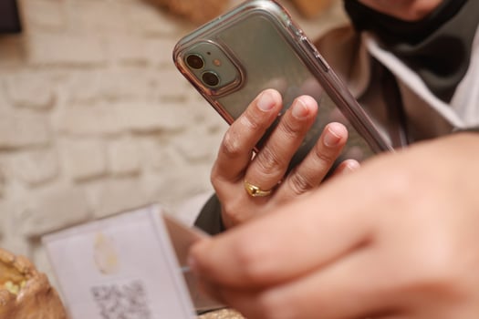 woman scan QR code with smart phone at cafe photo