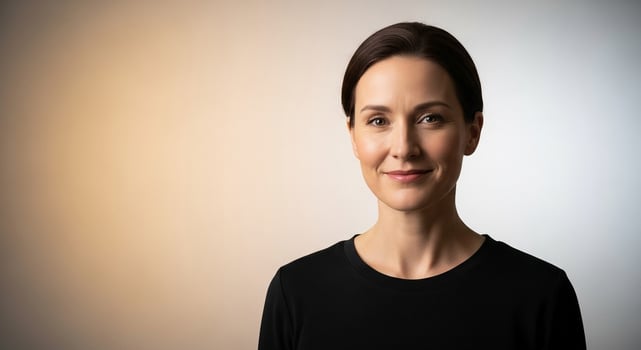 Portrait of a confident and attractive businesswoman smiling gently against a neutral studio backdrop, ideal for professional headshots and corporate communications. photo