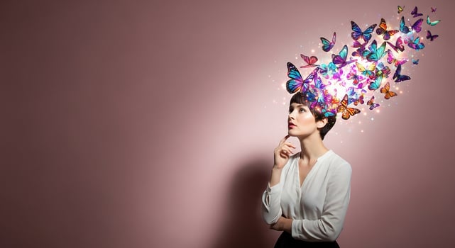 Thoughtful Woman with Glowing Butterflies Emanating from Her Head, Symbolizing Creativity, Imagination, and Inspiration photo
