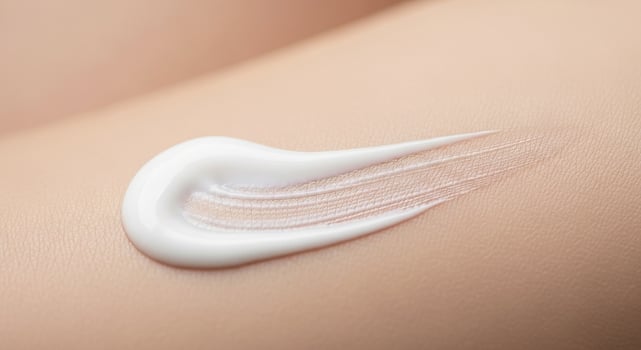 Close-up of white cosmetic cream applied to skin, showcasing texture and skincare concept, perfect for beauty and dermatology themes. photo