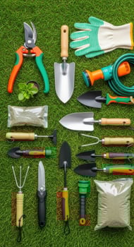 A collection of gardening tools and supplies laid out on green grass photo