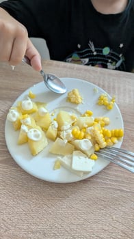A Beautifully Colorful Plate Filled with Fresh Fruits and Corn Arranged on a Table photo