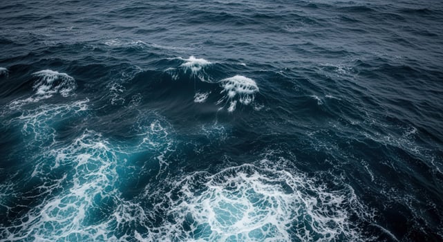 Churning ocean waves with white foam and deep blue water photo