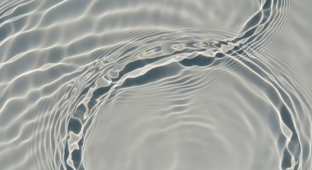 Curving lines of light on a rippling water surface photo