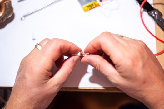 Worker in the workshop is engaged in LED repair photo