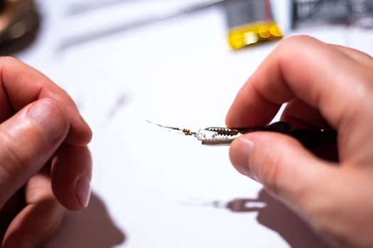 Worker in a workshop repairing an LED. photo