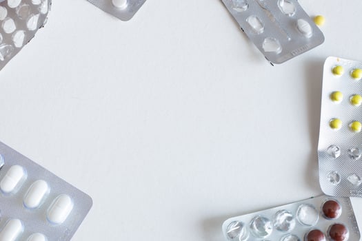 pack of blisters with different pills on a white background with. photo