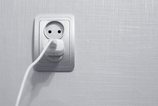 the cord is plugged into an outlet. photo
