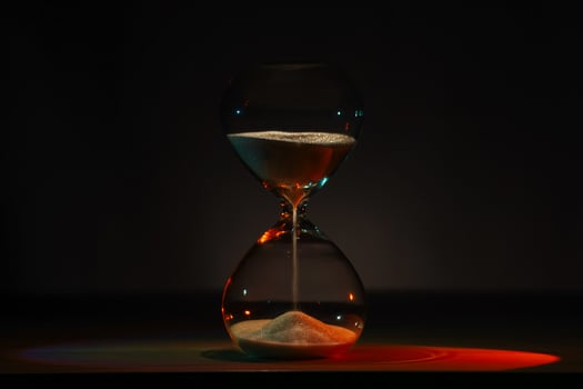 artistic glowing neon hourglass, symbolizing time and creativity. Vibrant lighting against a dark minimalist backdrop. Concepts of time management, life balance, and artistic design photo