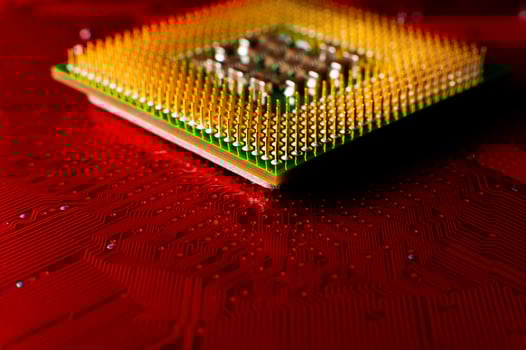 Electronic components. Electronic printed circuit board close-up, accent red color photo