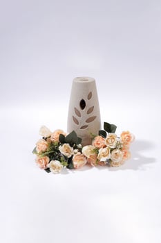 Air Freshener Diffuser with Artificial Roses on White Background photo