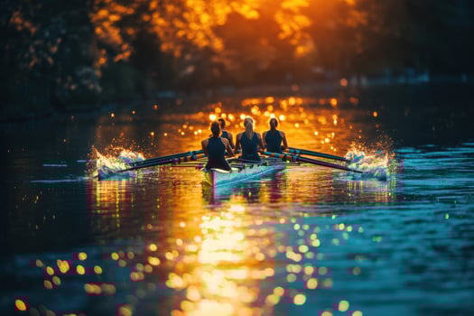 Four rowers in a boat on a river at sunset photo