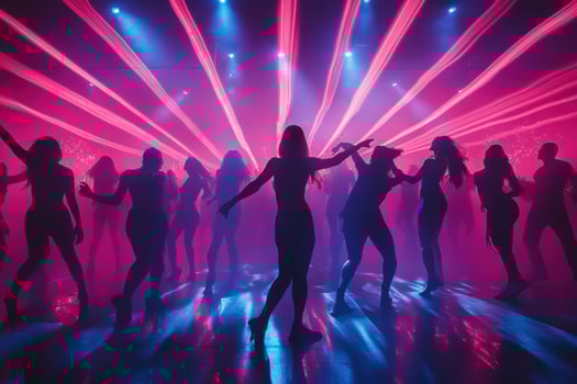 Silhouettes of people dancing in a nightclub photo