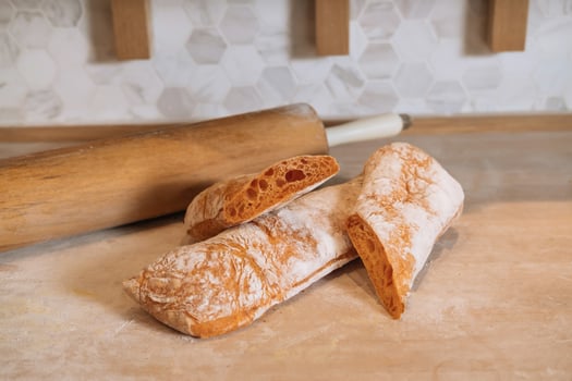 Ciabatta Bread with a Hint of Tomato isolated on Wooden background side view of italian Baked Food photo