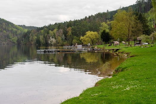 Nova Zivohost, Czech Republic - April 24, 2025. Lakeside dock and green spring landscape photo