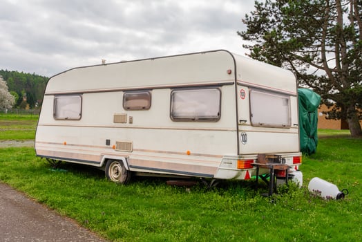 One vintage travel trailer in green campsite near Slapy lake in Nova Zivohost, Czech Republic. photo