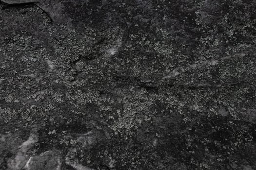 Dark stone texture with natural rough surface and layered structure in Czech Republic photo