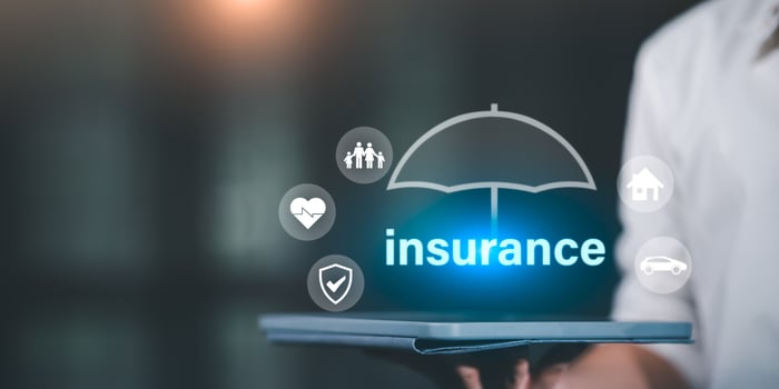 Insurance concept with umbrella icon over tablet device, representing protection coverage for family, health, home, and car in digital insurance platforms and financial planning solutions. photo