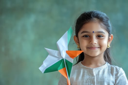 Happy girl holding pinwheel with indian flag photo